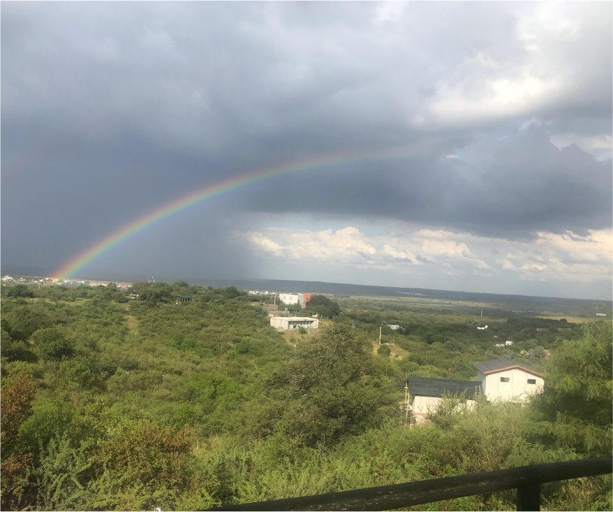 A rainbow over a lush, green valley.