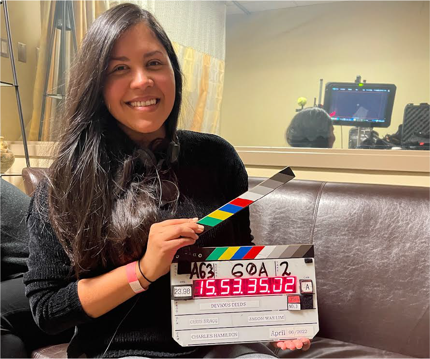 Mariannjely Marval holding a clapboard